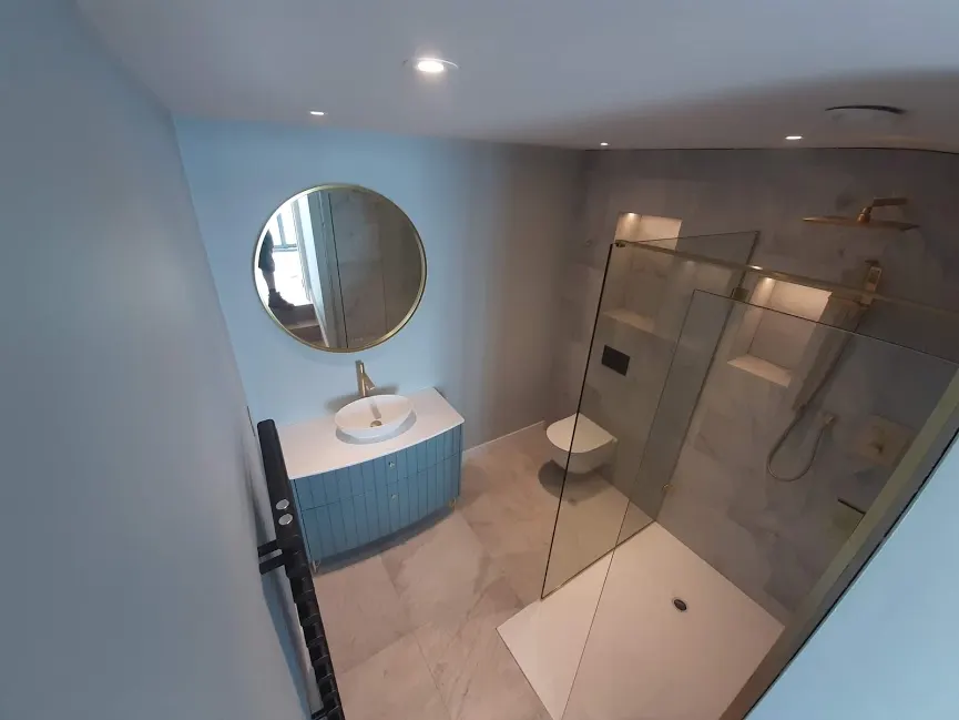 New bathroom with walk-in shower and round mirror