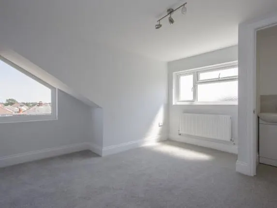 Finished loft bedroom with carpet and sloped ceiling