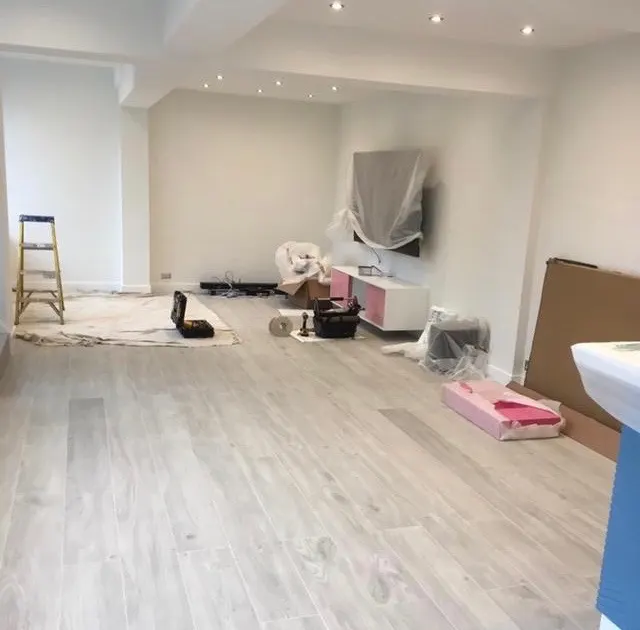 Open-plan room being finished after a wall was removed
